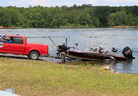 Volunteers help anglers back their tow vehicles down the ramp and hook up their boats before sending them back to parking on Day One of the BASS Southern Open #2 on Smith Lake.