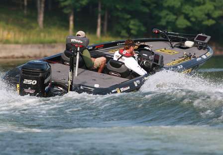 Elite Series pro Gerald Swindle, the leader coming into Day Two, guns from one place to another, hunting for largemouth.