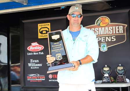 Co-Angler Robert Dice holds the hardware that will grace his mantle, and dreams about the Triton that will grace his garage after he takes the win on Smith Lake.