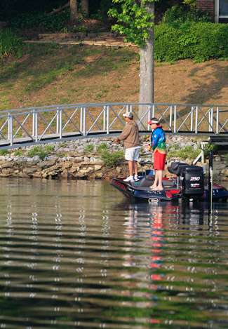 Todd Auten skips a white swimming jig under a row of docks on Smith Lake.