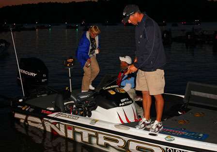 Edwin Evers checks the action of a bait as the BASS staff prepares a BASSCast camera for his day of fishing.