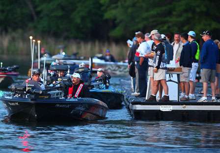 Kevin Wirth leads a line of boats out onto the lake as tournament officials and fans watch the launch Thursday.