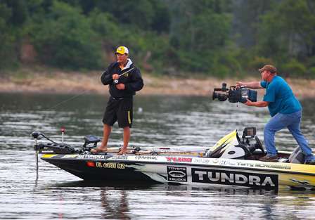 Scroggins quickly hooks up on his first fishing spot of the day, and ESPN cameraman Rick Mason moves in to capture the catch. 