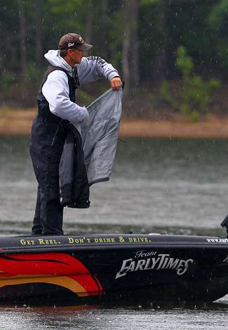 As the early morning shower turned into a hard rain, Wirth breaks out his raingear. 