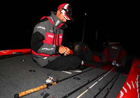 Casey Ashley makes some last minute adjustments to his lures while waiting for it to get light enough to take off Sunday morning. 