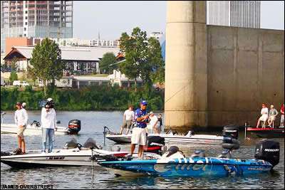 Scott Rook fishes near downtown Little Rock with spectator boats nearby.