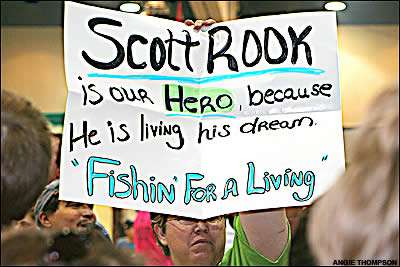 A Scott Rook fan holds a sign in the audience.