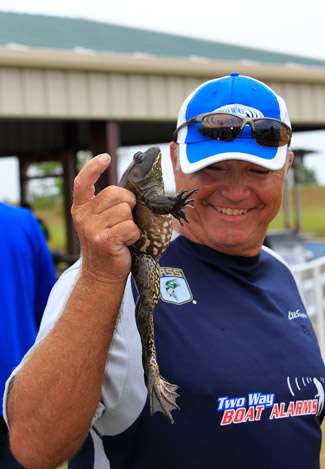 Pro Lee Sisson holds up a frog that he caught early on Day One. The bait it shoved into its mouth? A topwater frog. Lee quipped he was on a 