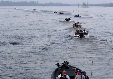 An orderly line of competitors make their way out onto the Red River.