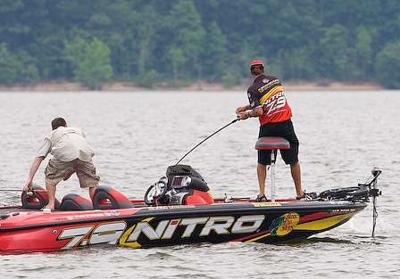 During Day Two, VanDam hooks up with a good fish, and his co-angler puts down his rod to give an assist.