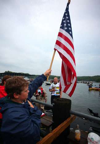 The flag is raised and anglers remove their hats for the playing of the national anthem.