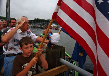 Anglers and fans remove their hats for the playing of the national anthem Thursday morning.