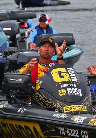 Gerald Swindle reaches up to grab the check-in float that a BASS official tossed his way.