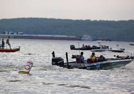 Paul Elias idles out from Paris Landing State Park as spectator boats wait for the angler they want to follow.