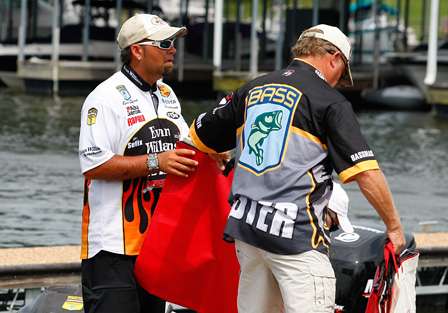 Jason Quinn grabs a bag from BASS tournament officials to weigh his catch on Day Two of the Tennessee Triumph.