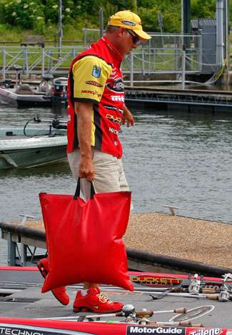 Boyd Duckett walks to the front deck of his boat with a full bag on Day Two of the Tennessee Triumph.