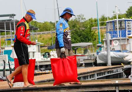 Rick Clunn and Greg Vinson walk down the dock at Paris Landing State Park on their way to the weigh-in.