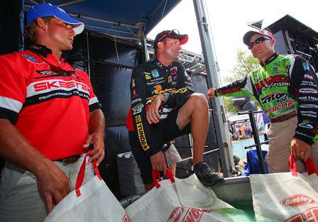 The first three anglers back to the dock, Keith Poche, Kevin VanDam and Brent Chapman, wait for the Day Two weigh-in to begin.