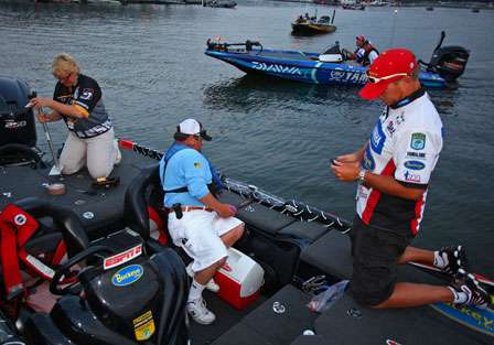 Russ Lane prepares a rod as a BASS official rigs a BASSCam camera for his day on Kentucky Lake.