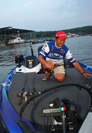 Yusuke Miyazaki organizes his rods on his front deck as he waits for the boats to begin leaving Paris Landing State Park.