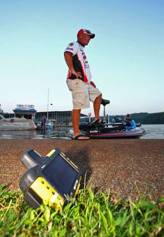 Scott Rook waits by his boat as a BASSCam camera waits to be installed on the final day of the Tennessee Triumph on Kentucky Lake.