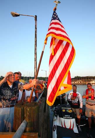 Anglers and fans remove their hats for the playing of the national anthem at Paris Landing State Park.