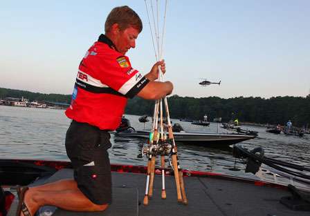 In second place, Kelly Jordon prepares his rods for a day of fishing as the helicopter circles overhead.