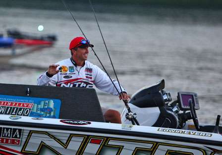 Edwin Evers grabs a few rods to place on the front deck on Day Four on the Tennessee Triumph.