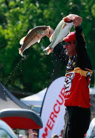 Kevin Van Dam reaches into the live well and raises a pair of Kentucky Lake bass for the crowd. The crowd's reaction was deafening.
