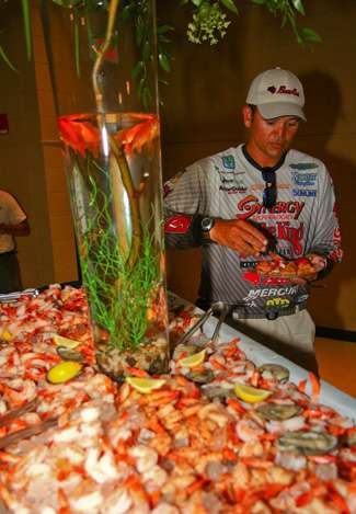 James Niggemeyer fills his plate from a large selection of shrimp. 