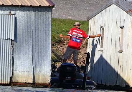 Marty Robinson squeezes into two floating boat docks to make a cast. 