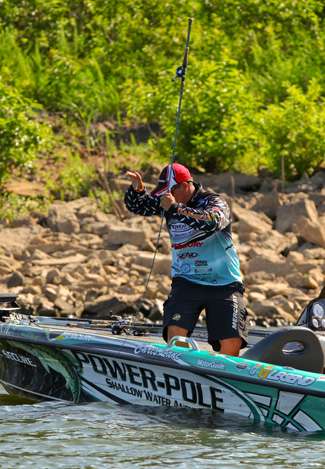 Lane raises his rod vertically to give the fish line without applying too much pressure. 