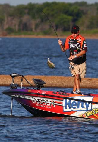 McClelland swings a keeper into the boat, caught near the same island he fished all day on Day One.