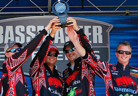 The team from the University of Arkansas holds the Bassmaster College Classic trophy high.