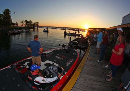 Pat Golden and his cameraman wait by the dock as the sun rises on Day Four of the AutoZone Sooner Run.