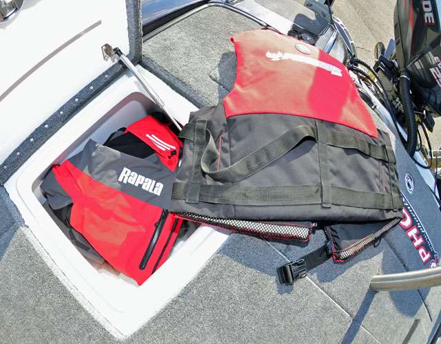Moving to the rear of his Phoenix, we find more PFDs and a rain suit in the starboard hatch.