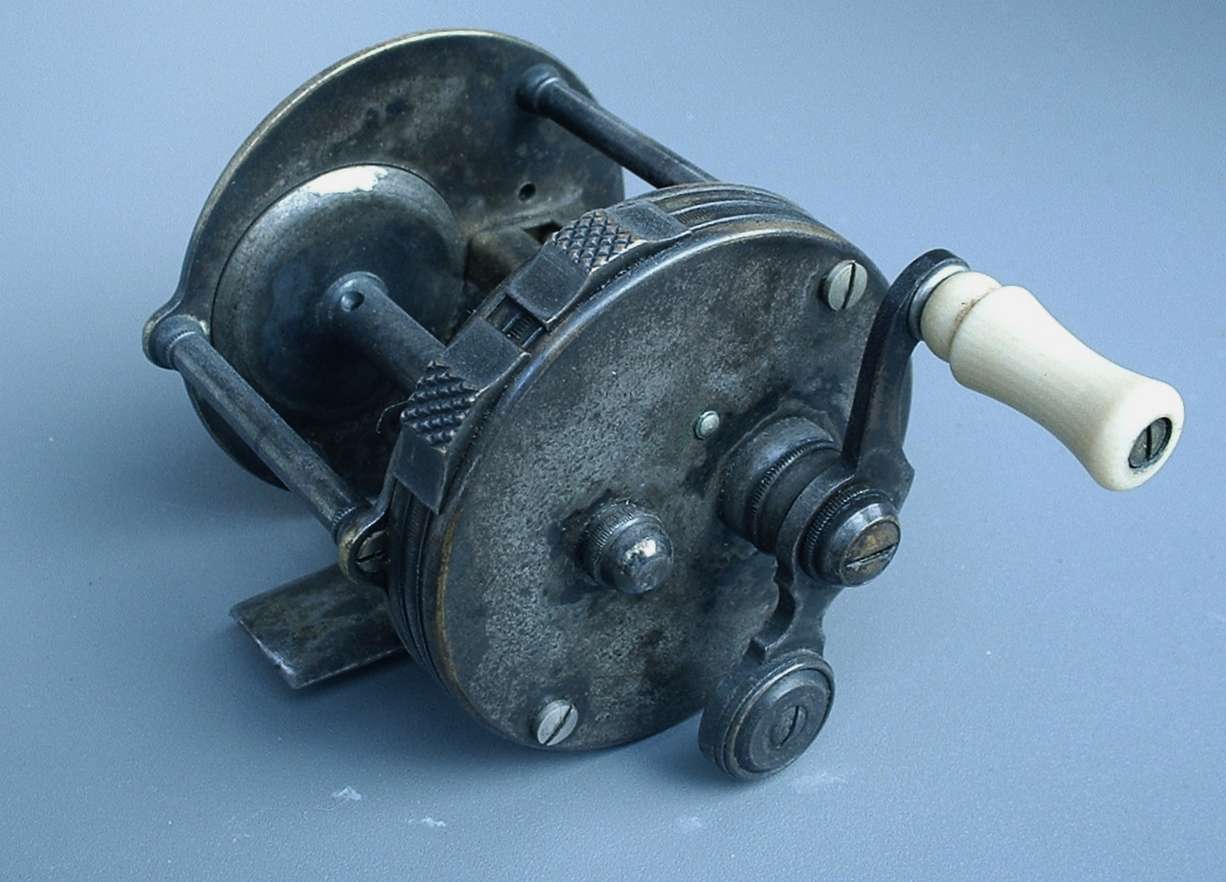 This model Style-C by the William Shakespeare Jr. Co. is considered the first production, level-winding bait-casting reel. Because of a thin silver wash, these reels take on a dark, tarnished look. If you find one, DO NOT polish it!