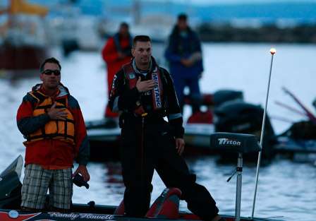 Elite pro Randy Howell and his co-angler for Day One stand and salute the flag as the national anthem is played.