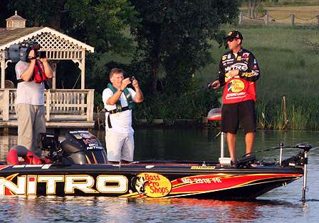 An ESPN cameraman and Bassmaster TV host Tommy Sanders do double duty taping VanDam after he moved deeper into New Lake.
