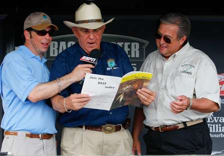 Ray Scott presents Wetumpka Mayor Jerry Willis with a copy of the first Bassmaster Magazine.