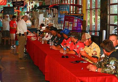 Anglers take a seat to sign autographs and visit with fishing fans. 