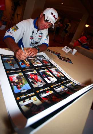 Terry Butcher pens his autograph to a poster that includes all the anglers that qualified for the 2010 Toyota Trucks Championship Week. 
