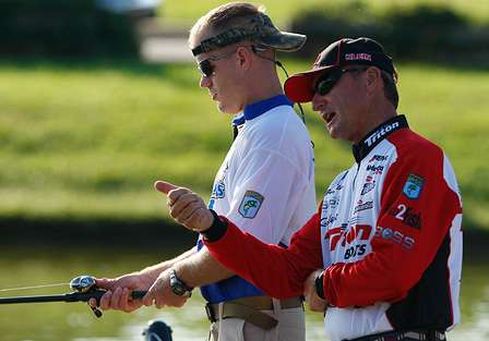 Before the competition began, the Elite anglers showed their Warrior partners how to cast and work their lures. Here, Gary Klein tells Sean DeBevoise the trick to a baitcaster is all in the thumb.