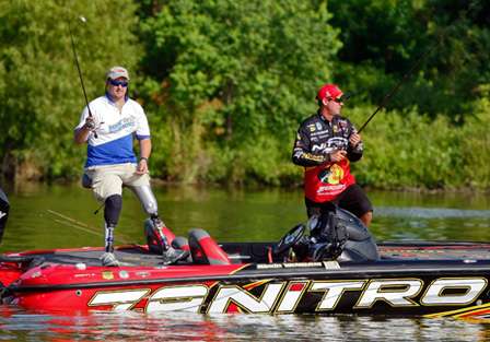 Kevin VanDam helps Jacque Keeslar free his lure from the many snags on the bottom of the lake.
