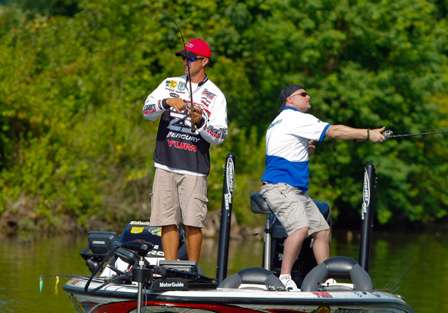 Edwin Evers hooks into a small bass as Timothy Murray makes a long cast off the back deck.