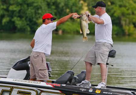 Murray and Evers congratulate each other after putting a giant largemouth in the boat.