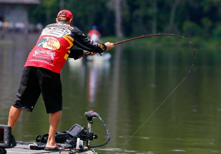 VanDam holds out his rod to steer a bigger fish around the front of his trolling motor.