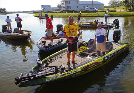 Elite anglers and their partners mill around the dock prior to 