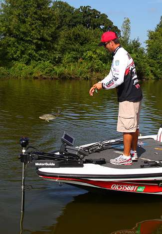 Evers dumps a small bass back into the lake, still searching for the one big fish that will put them on top.