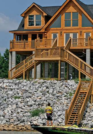 Remitz fishes the rocks by a newly constructed home on the Alabama River.